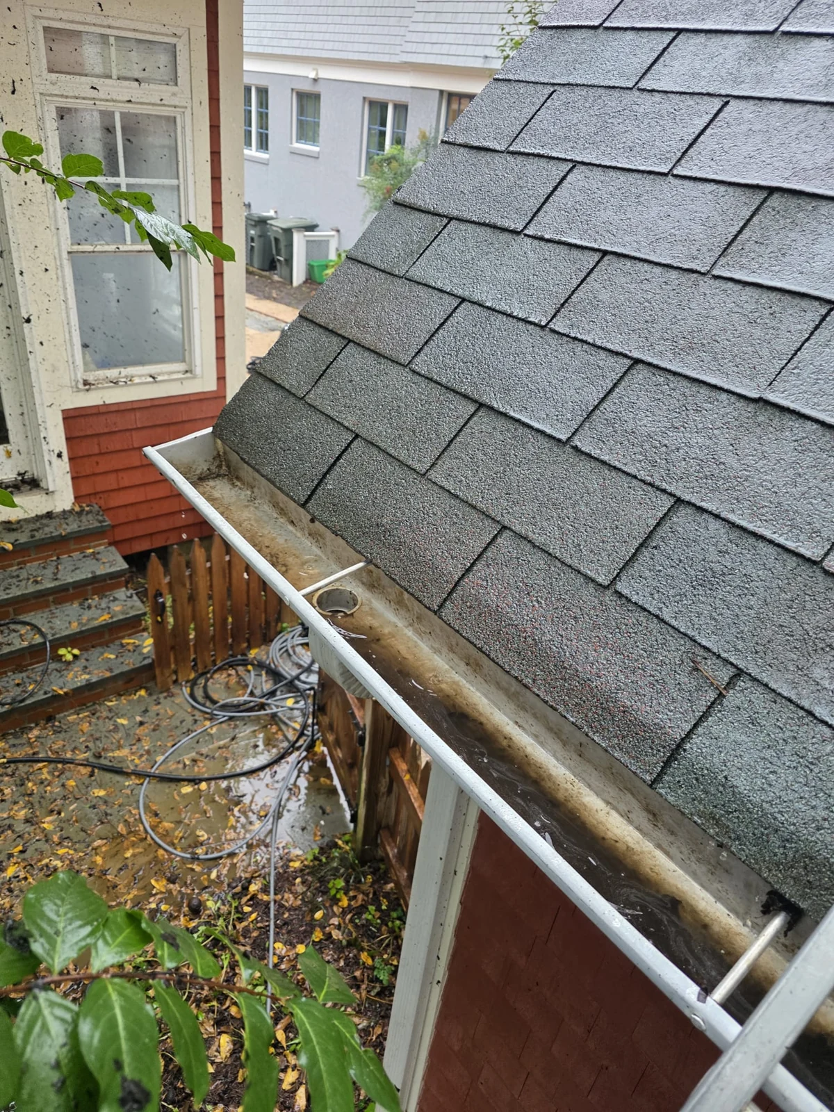 An open gutter section with leaf buildup removed.