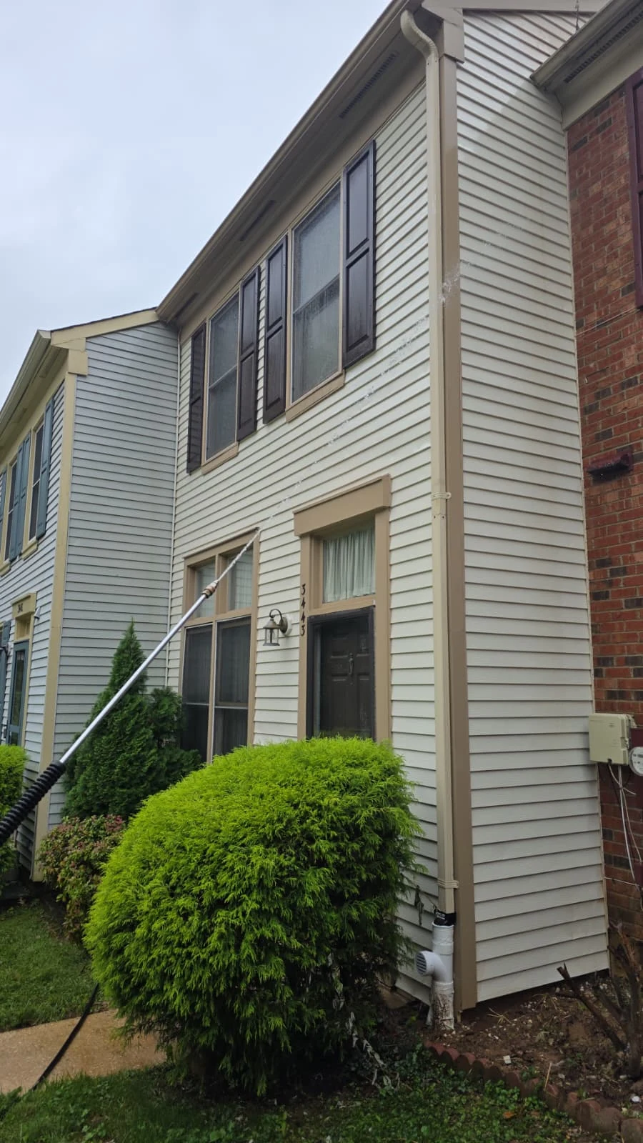 Washing the siding of a residential property.